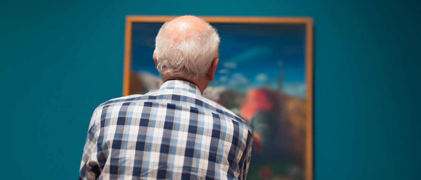man looking at a painting