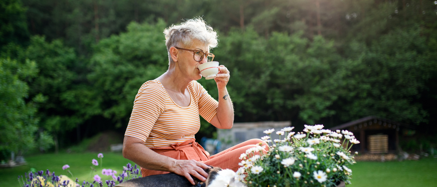 Senior Women Drinking Coffee Outside Enjoying Nature 