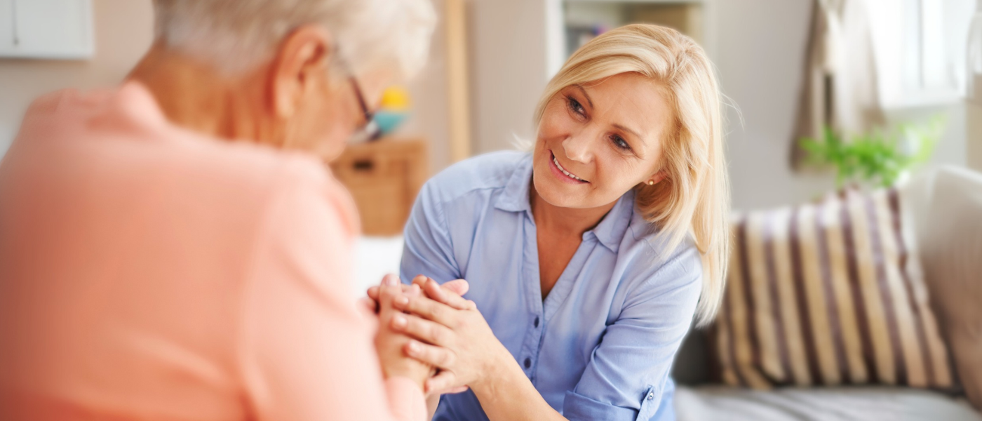 Woman communicating with an elderly loved one 