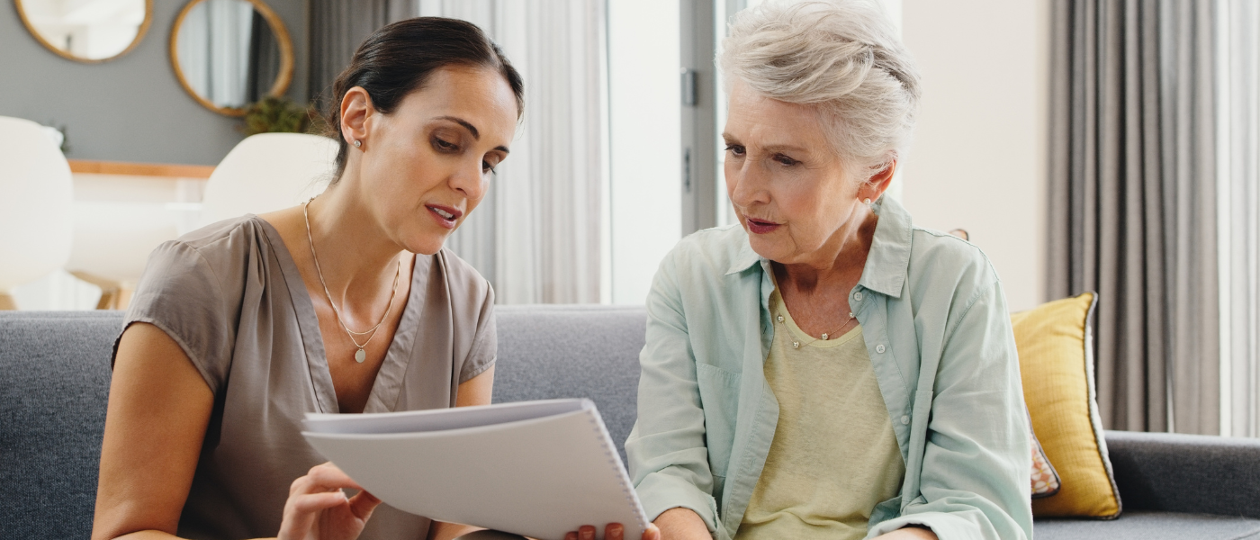 Older adult woman reviews care plan with senior living employee