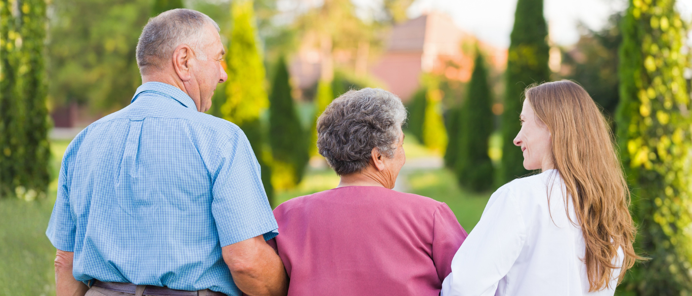Woman walking in nature with elderly parents 